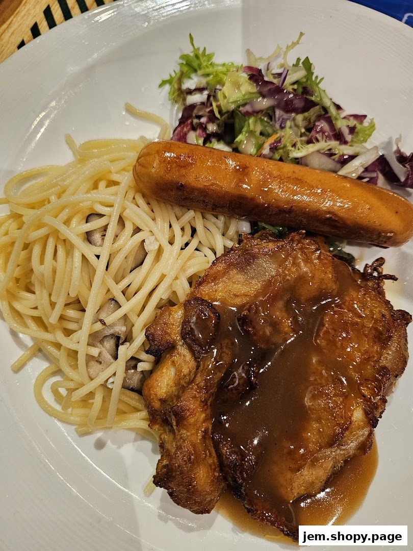 A plate of spaghetti with a sausage, chicken, and salad.