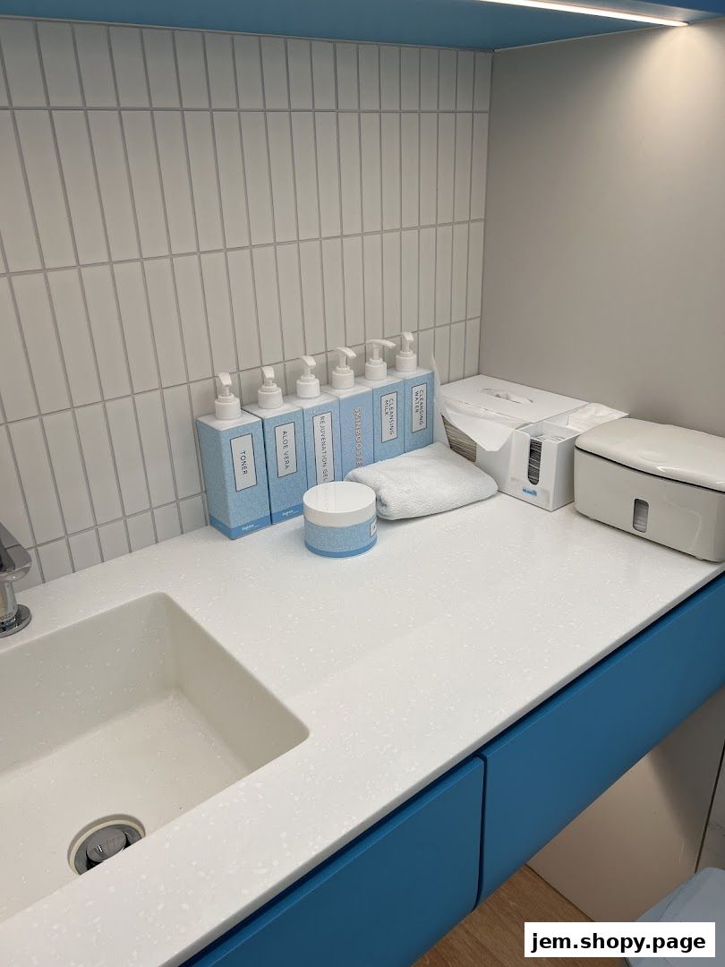 A clean vanity area with skincare products and a sink.