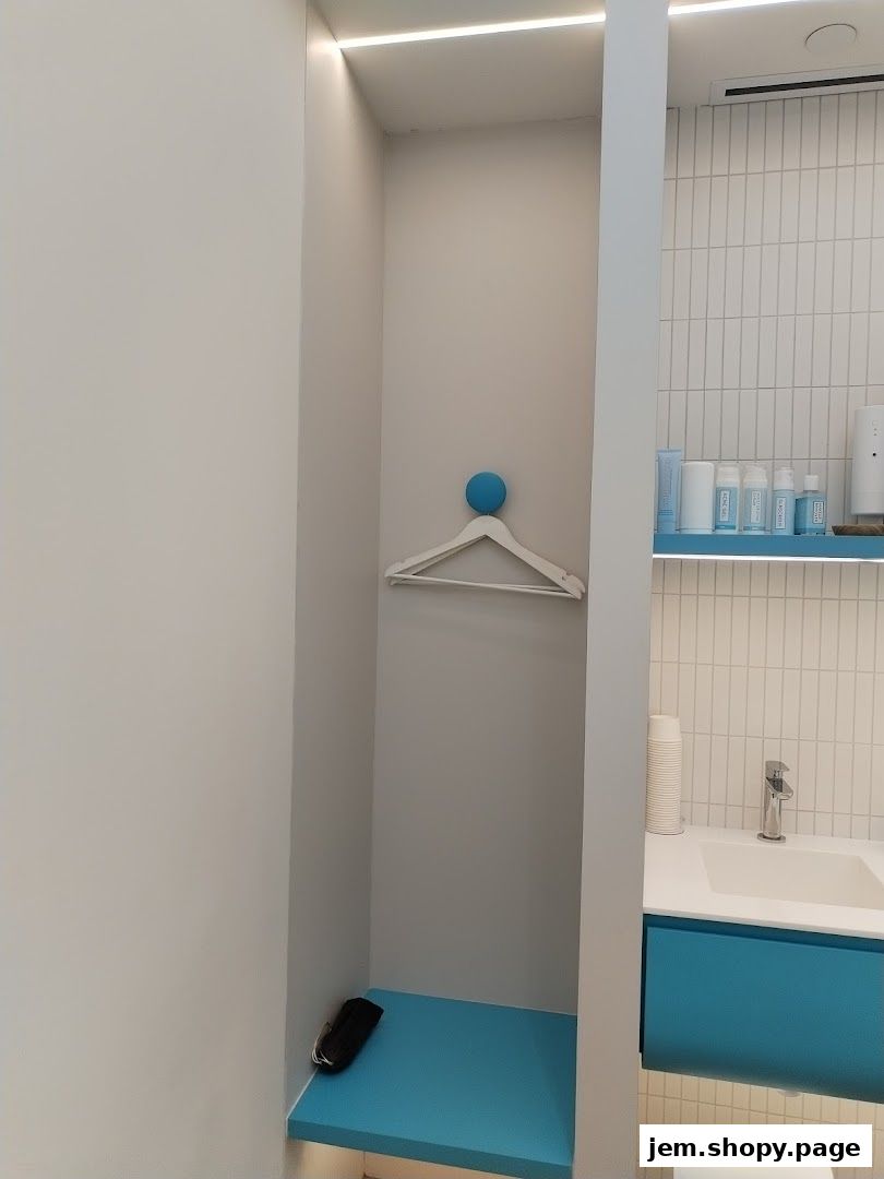 Interior of a clean, modern salon with a changing area and sink.