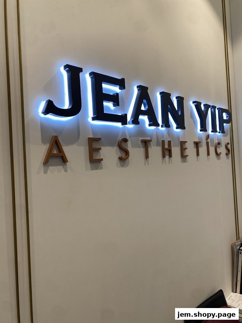 Illuminated signage for Jean Yip Aesthetics with the brand name prominently displayed.