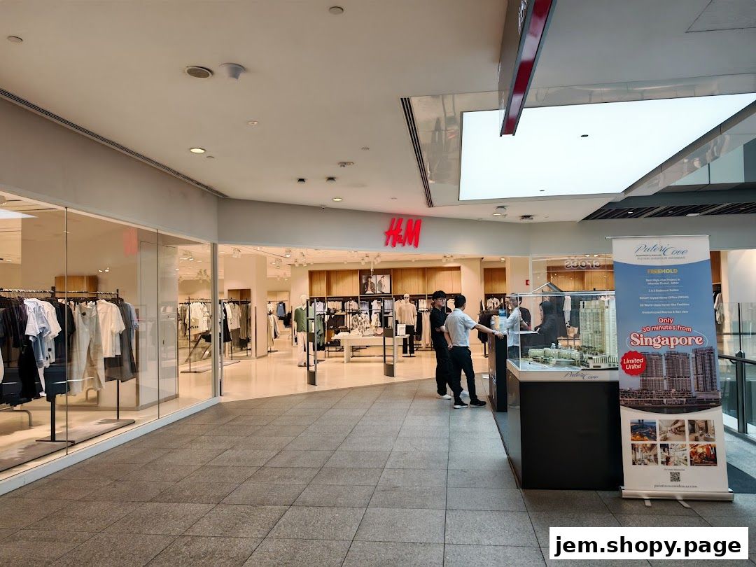 The H&M store entrance with clothing displays and a real estate advertisement.