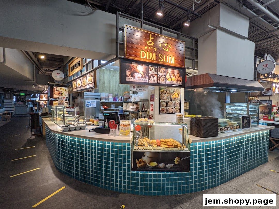 A food stall named Jem serving dim sum with a display of food and a steaming cooking area.