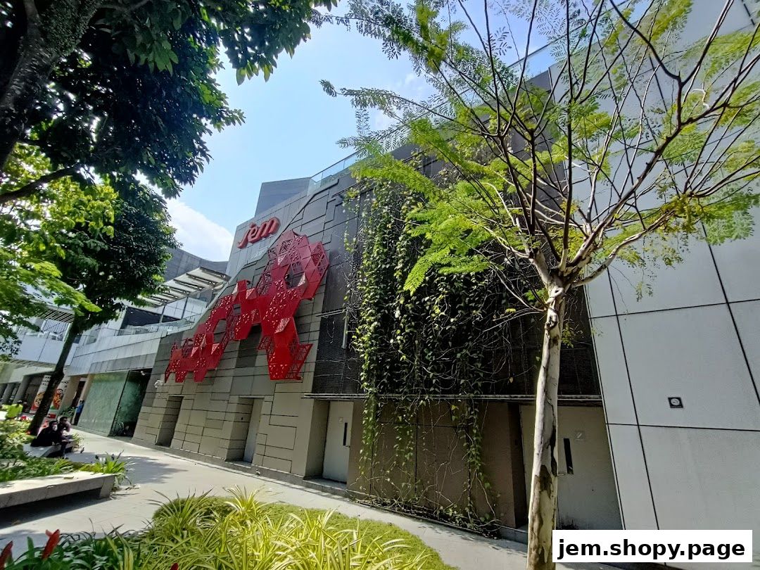 The exterior of the Jem shopping mall with a large red geometric art installation.