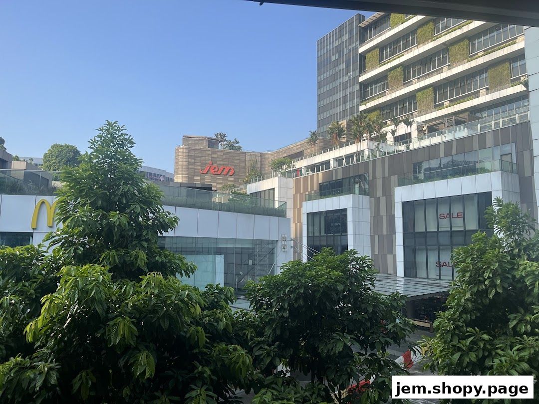 A view of the Jem shopping mall exterior with trees in the foreground.