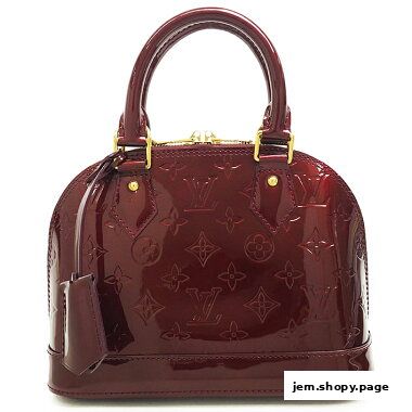 A glossy, burgundy Louis Vuitton Alma handbag with the signature monogram pattern.