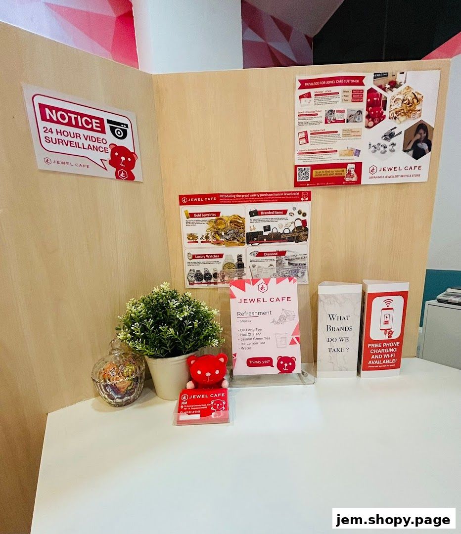 A display at Jewel Cafe featuring a surveillance notice, product information, and refreshment options.