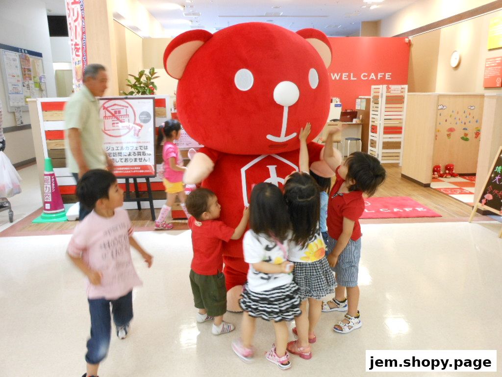 Children interact with a large red bear mascot at Jewel Cafe.