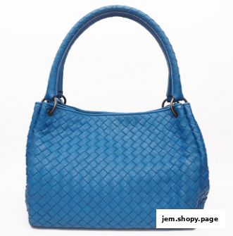 A vibrant blue woven leather handbag with a classic design and comfortable handles.