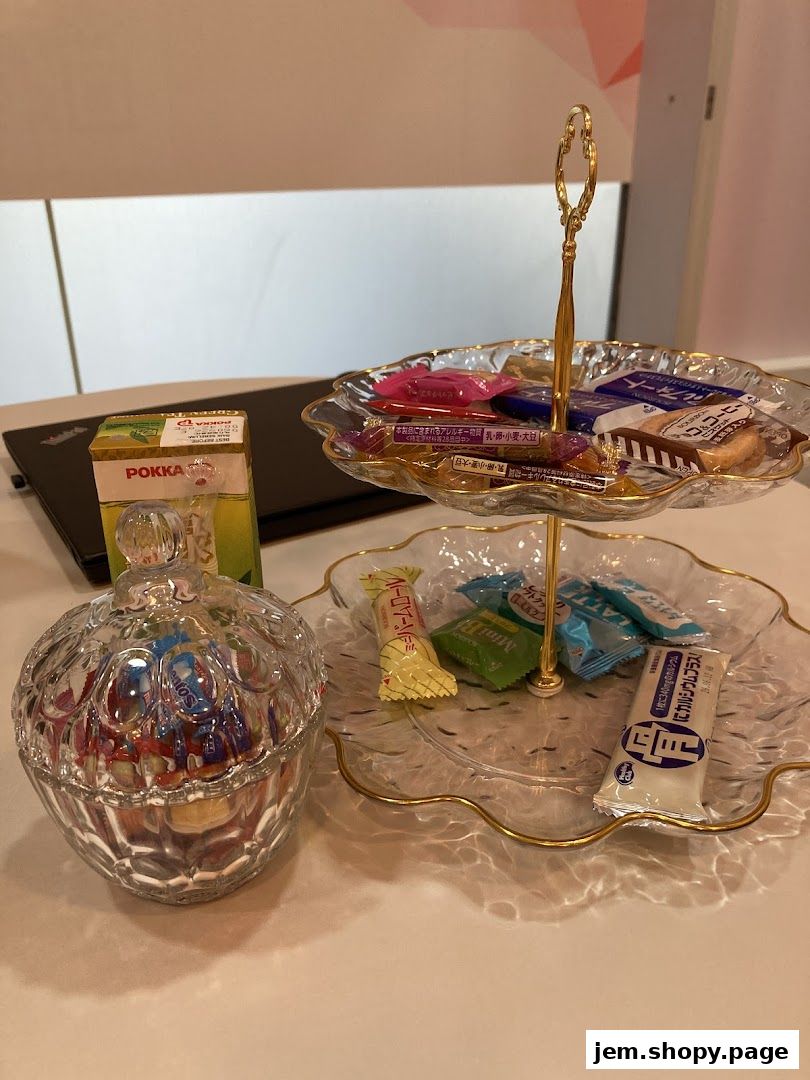 A crystal candy dish and a two-tiered stand filled with assorted sweets and snacks.