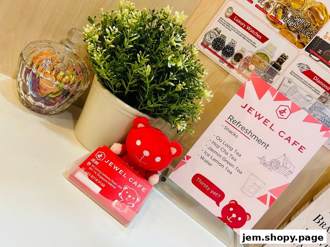 A display featuring a menu, business cards, and decorative items for Jewel Cafe.