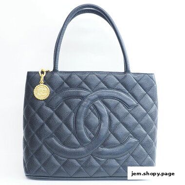 A black quilted leather tote bag with the iconic Chanel logo and a gold charm.