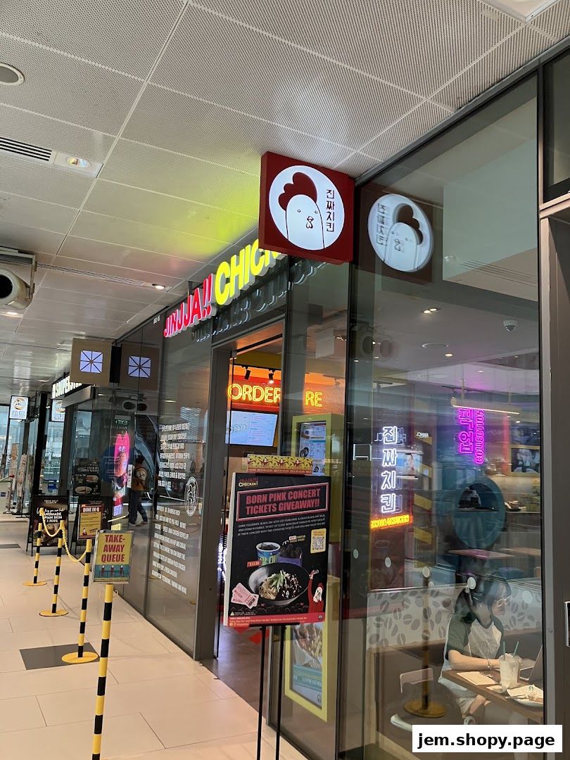 Exterior of Jinjja Chicken restaurant with signage and a promotional poster.