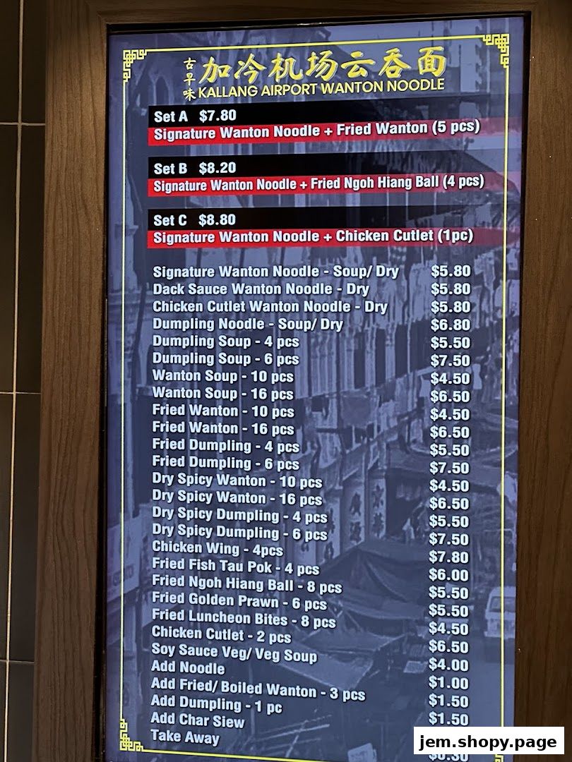 A digital menu board displaying various noodle sets and side dishes with prices.
