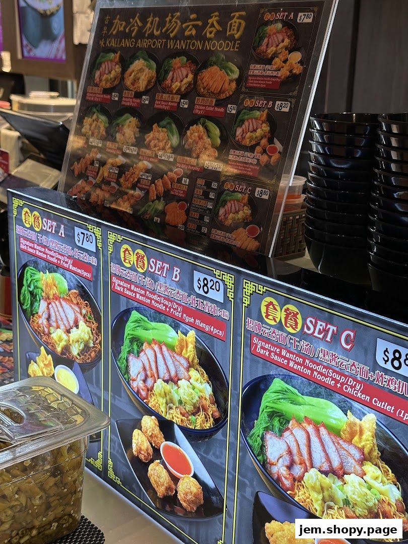 A menu board displaying various sets of wanton noodles and side dishes.