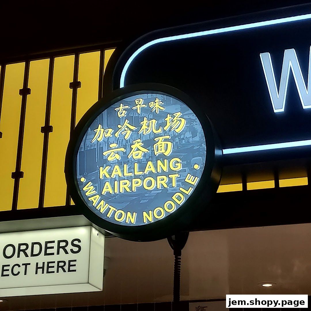 A sign for Kallang Airport Wanton Noodle with Chinese and English text.