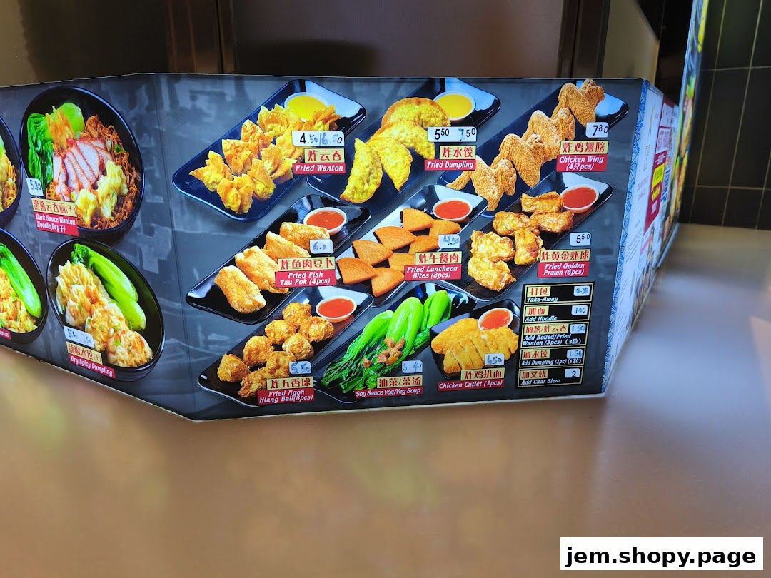 A menu board displaying various fried food items and noodle dishes from Kallang Airport Wanton Noodle.