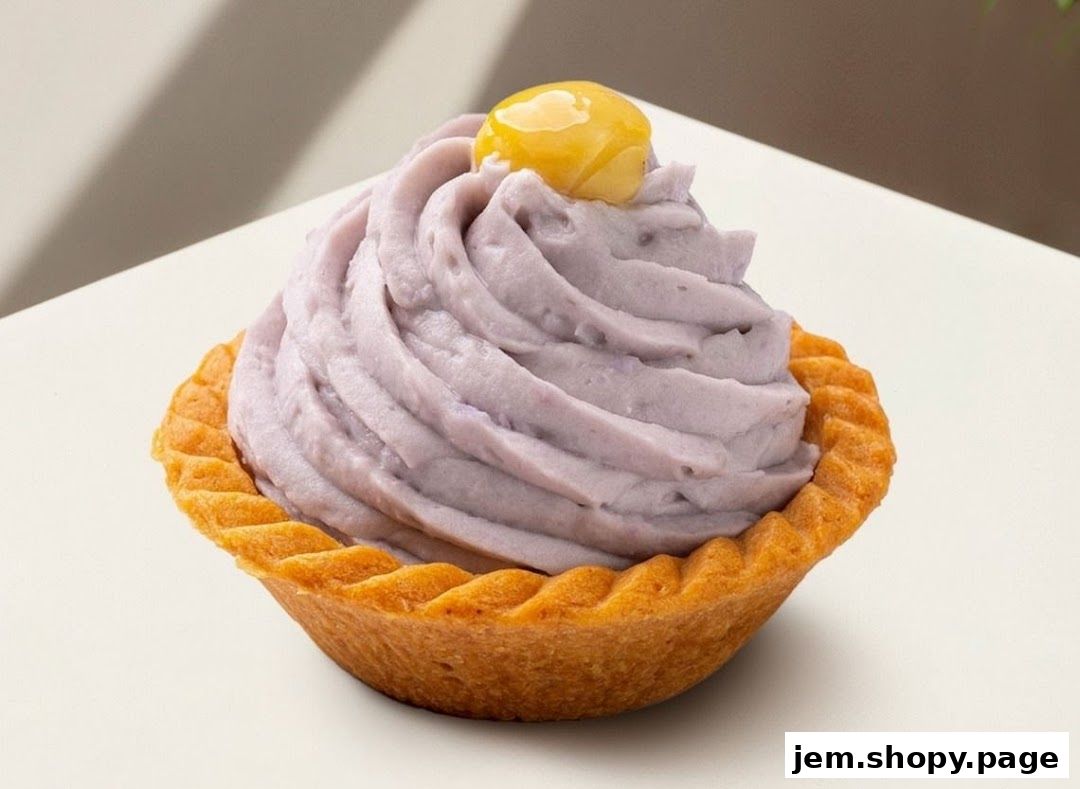 A close-up of a purple tart topped with cream and a yellow garnish.