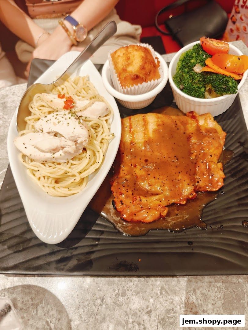 A delicious meal featuring grilled chicken, pasta, a muffin, and steamed vegetables.