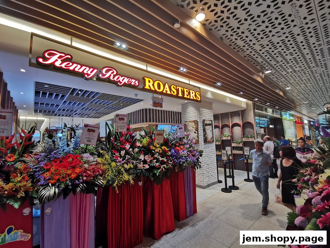 Kenny Rogers Roasters Singapore storefront with vibrant floral displays and signage.