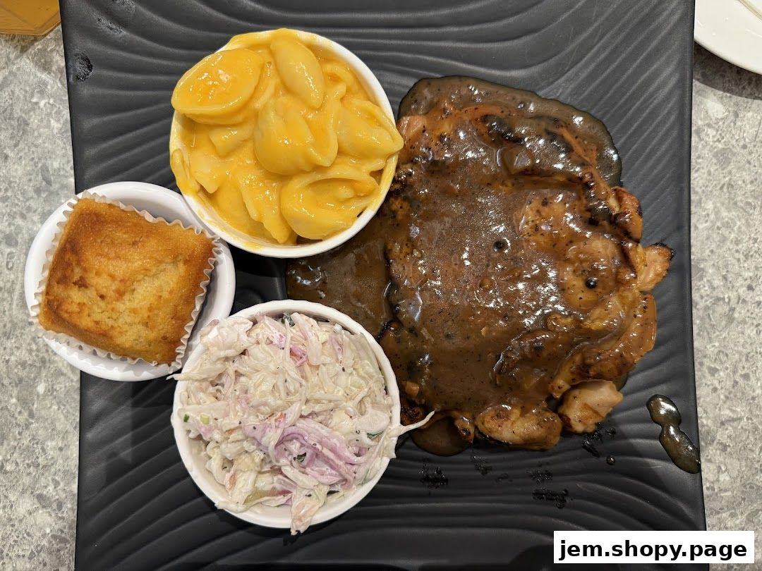 A delicious Kenny Rogers Roasters meal featuring chicken, mac and cheese, coleslaw, and cornbread.