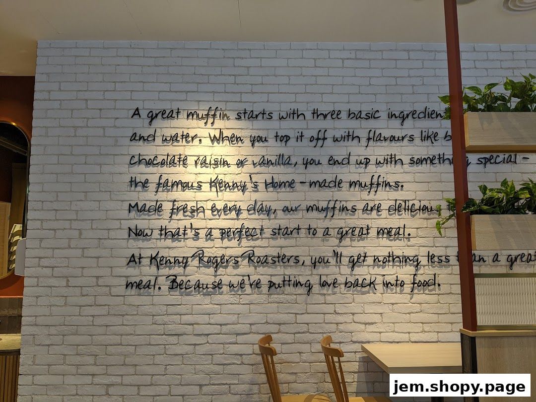 A white brick wall with a quote about muffins and food from Kenny Rogers Roasters.