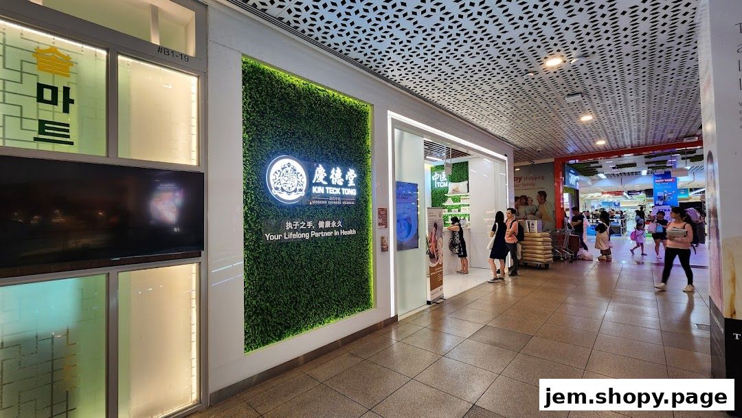 The exterior of Kin Teck Tong TCM Clinic with a green moss wall and prominent signage.