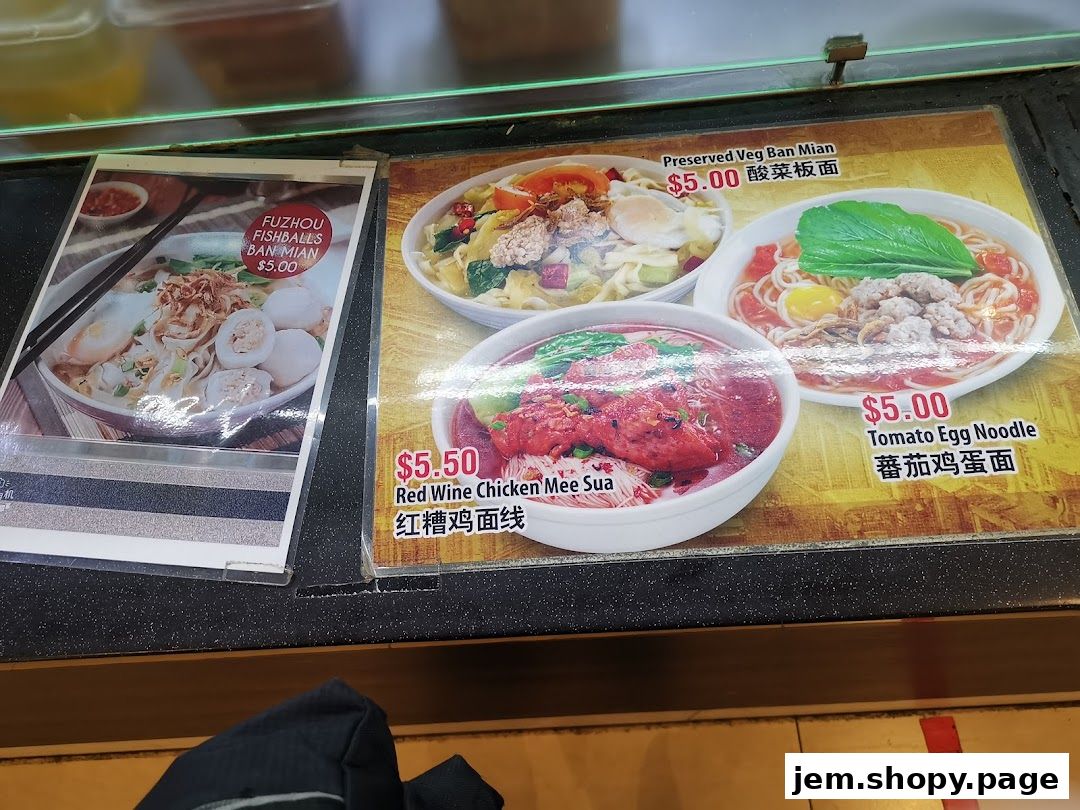 A display of various noodle dishes with prices and images.