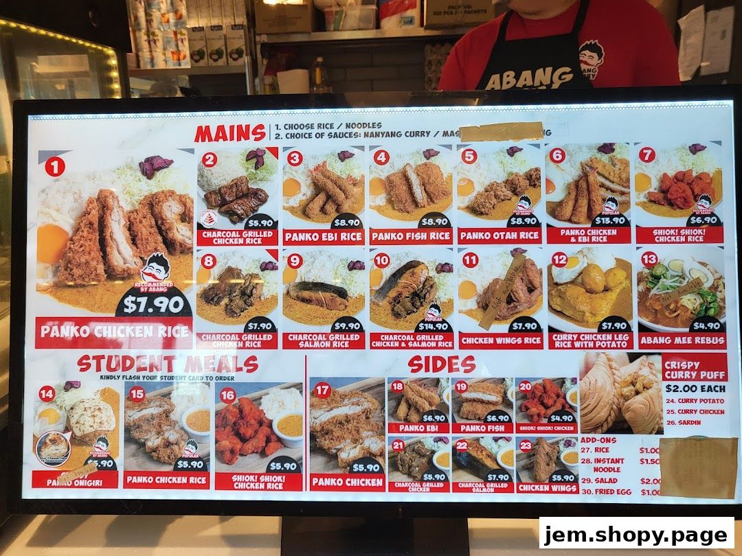 A digital menu board displaying various main dishes, sides, and add-ons with prices.