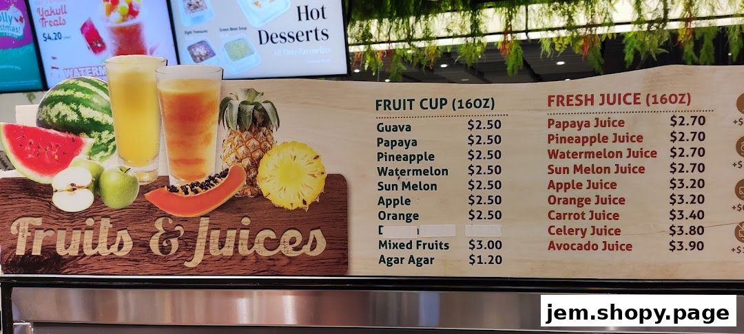 A menu board displaying fresh juices and fruit cups with prices.