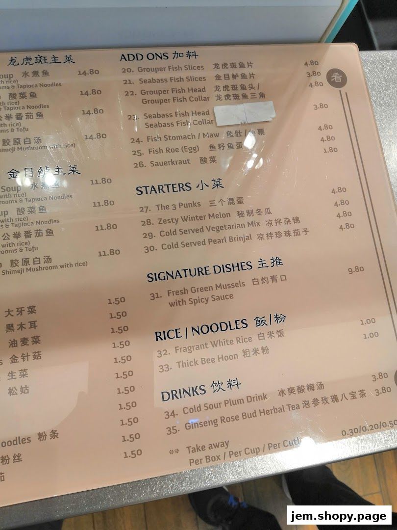 A close-up view of a menu with various food and drink items listed with prices.