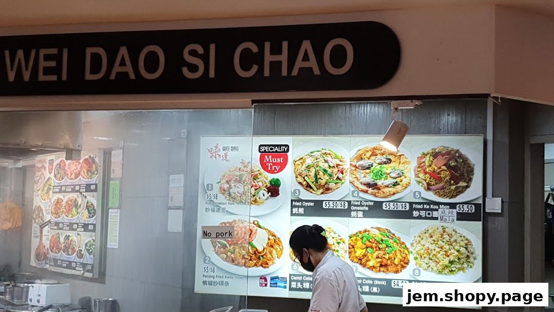 A food stall menu displaying various noodle and rice dishes with prices.
