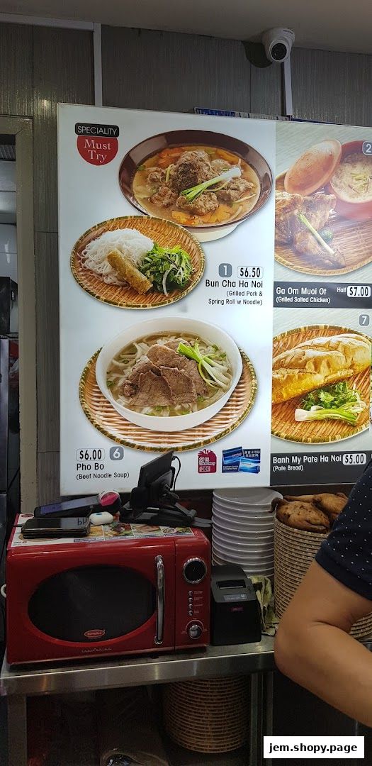 A menu board displaying Vietnamese dishes like Pho Bo and Banh My.