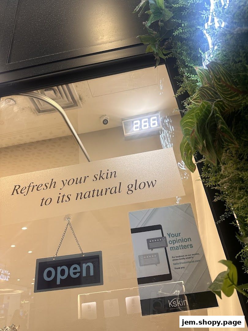 Shop window display with 'open' sign, promotional text, and greenery.