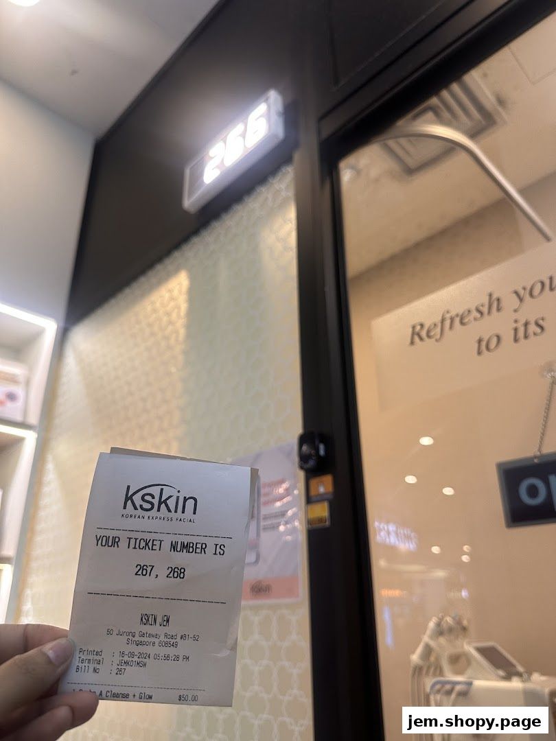 A hand holds a Kskin Korean Express Facial ticket outside the shop.