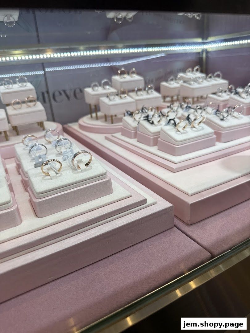 A display case filled with various rings, showcasing elegant designs and precious metals.