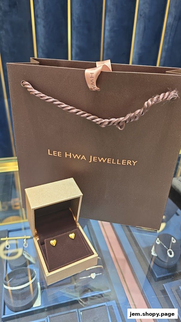 A jewelry box with heart-shaped earrings and a shopping bag from Lee Hwa Jewellery.