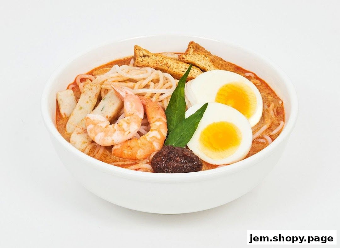 A bowl of delicious Laksa with shrimp, egg, tofu, and fish cakes.