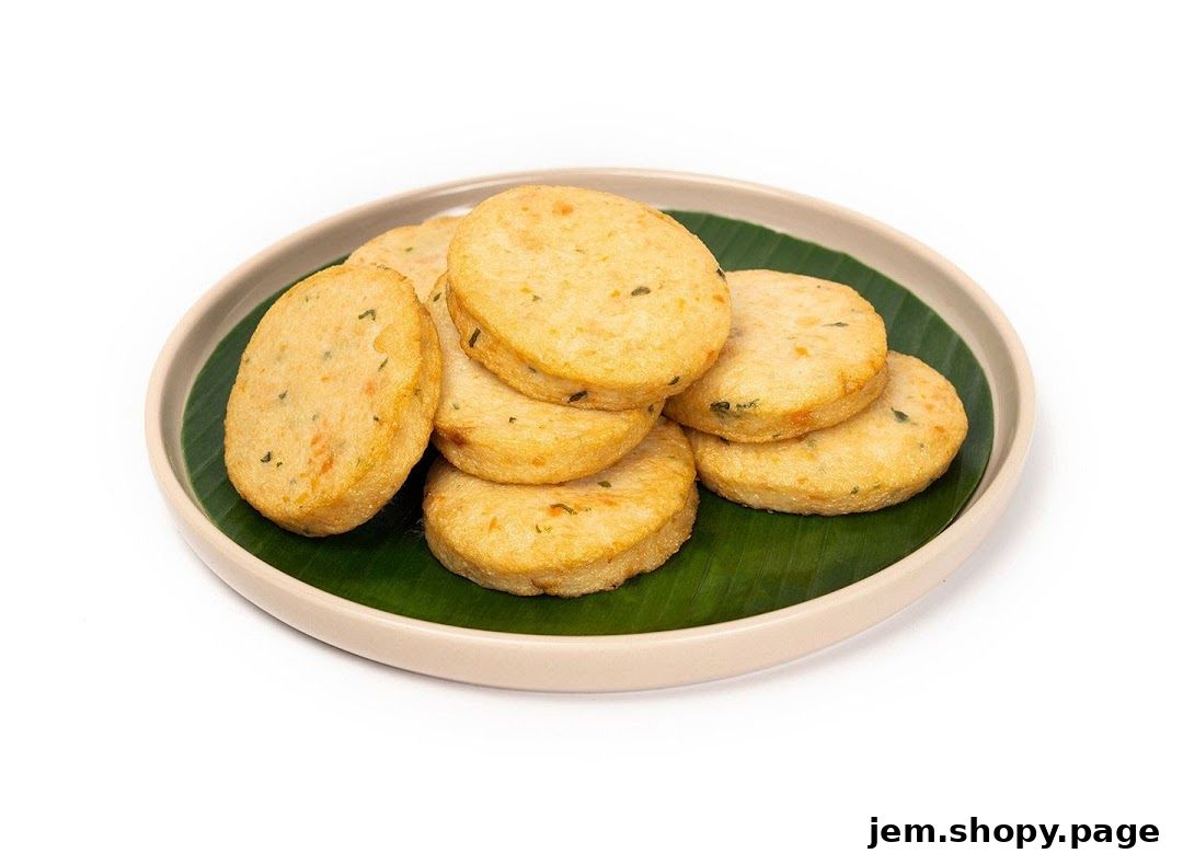 A plate of golden-brown fish cakes served on a banana leaf.