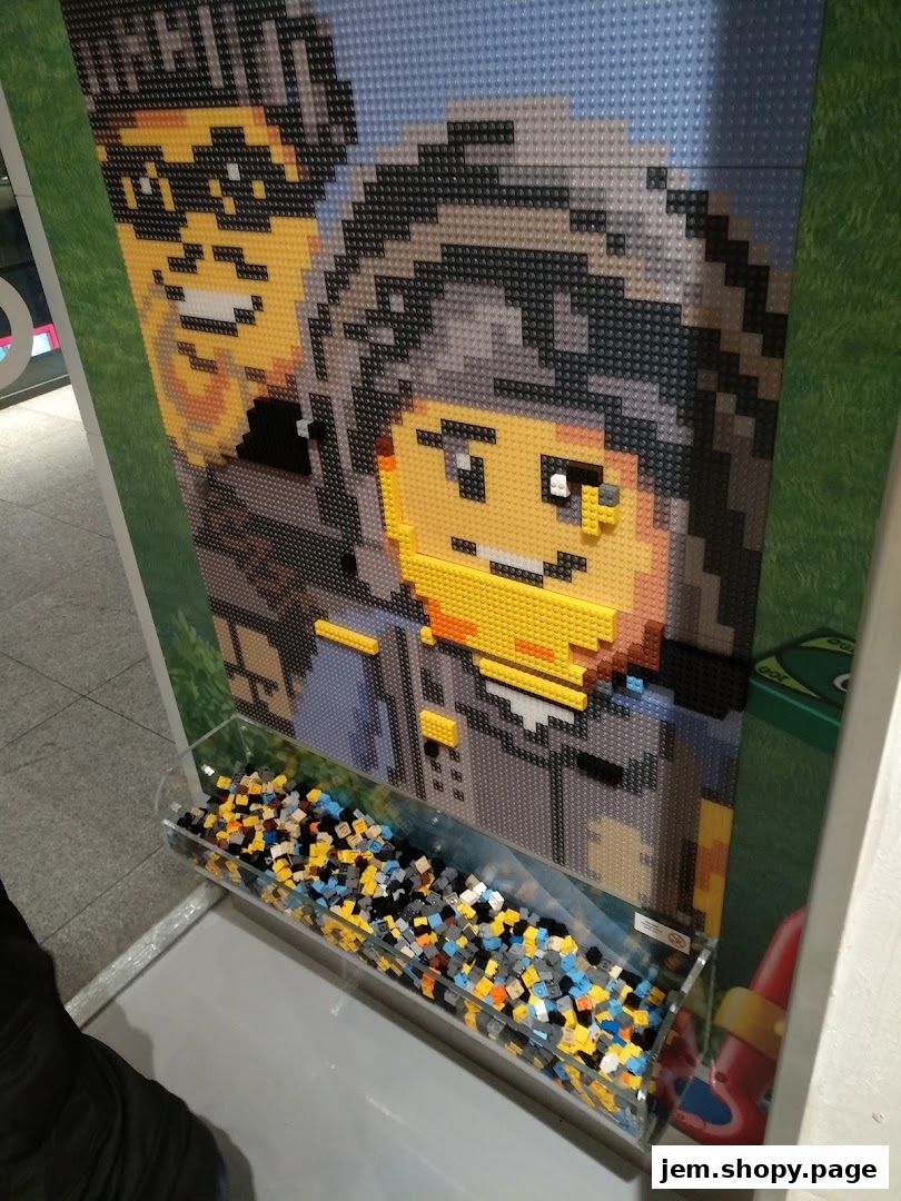 A LEGO mosaic of two people with a bin of loose LEGO bricks below.