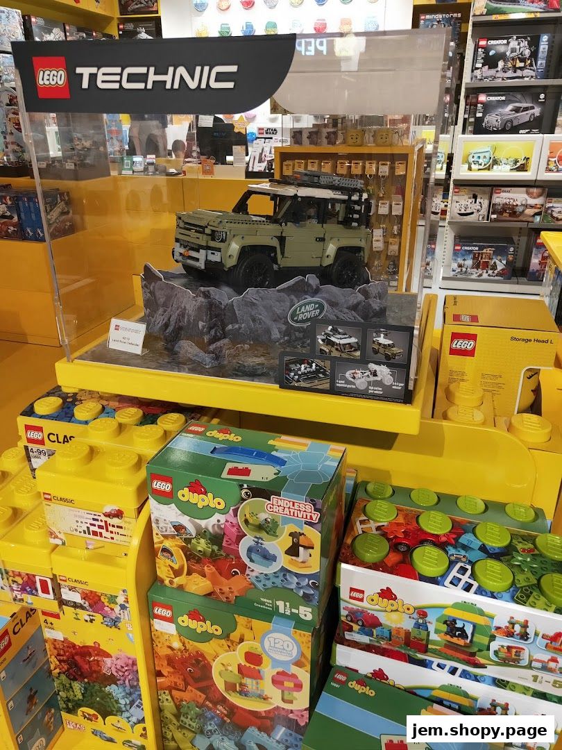LEGO Technic Land Rover Defender display with various LEGO sets on shelves.