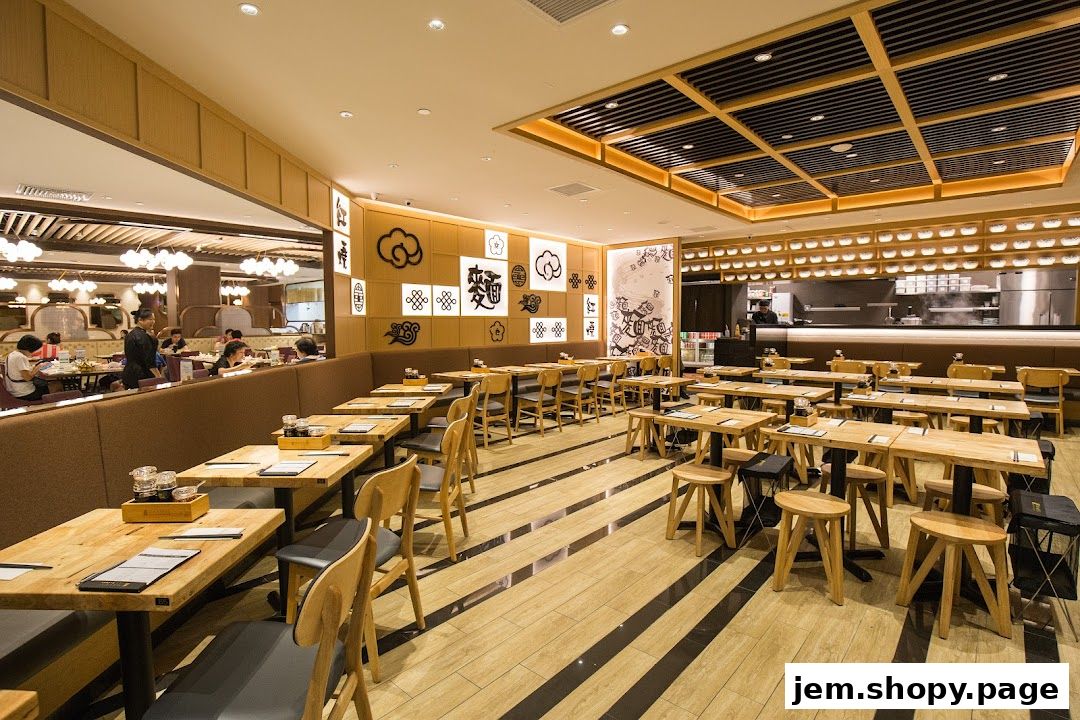 Interior view of LeNu Chefs Wai Noodle Bar with wooden tables and chairs.