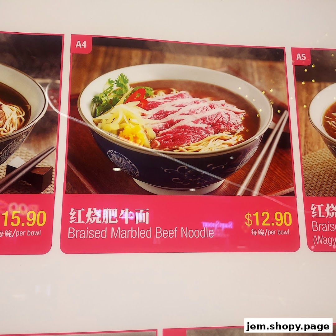 A close-up of a menu board showing two noodle dishes with prices.