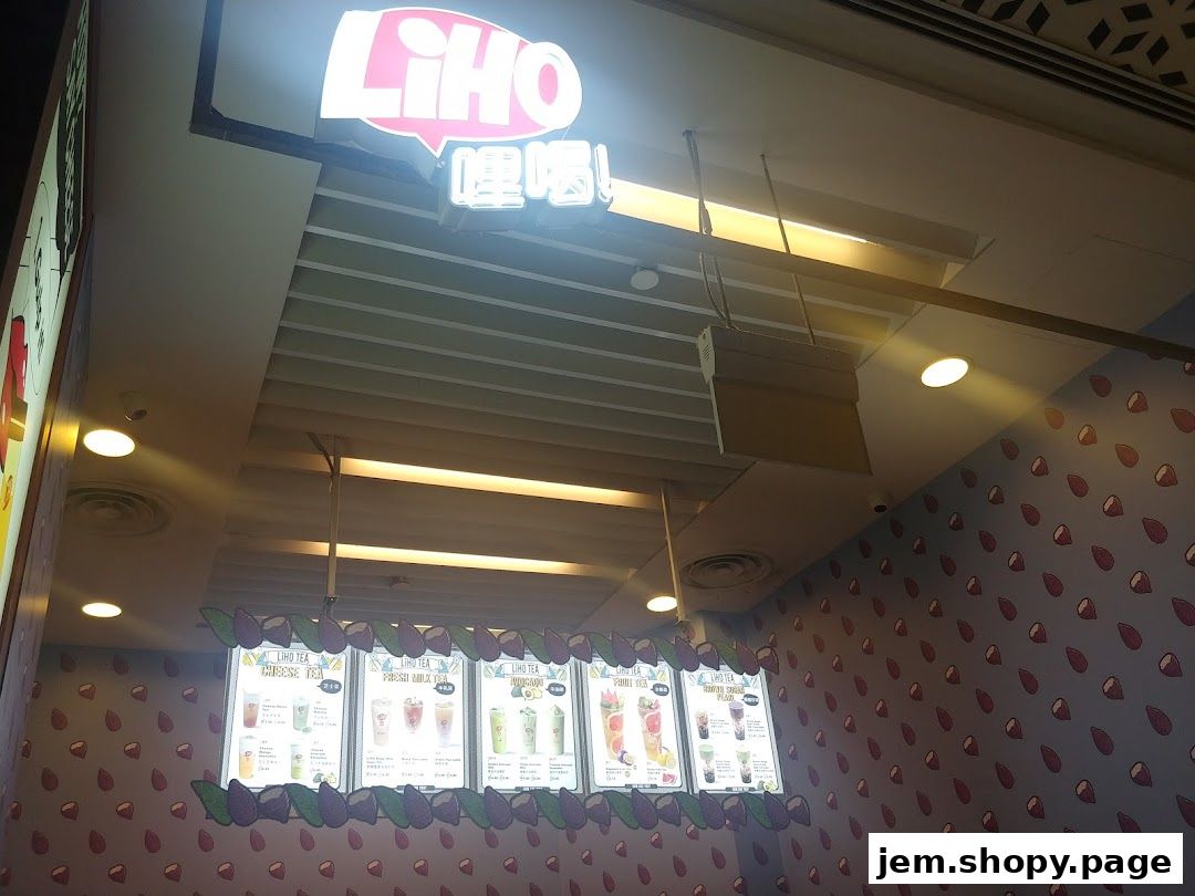 A brightly lit LiHO TEA menu display showcasing various drinks and their prices.