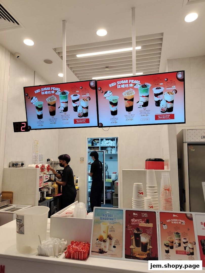 A digital menu board displaying various Red Sugar Pearl drinks at LiHO TEA.
