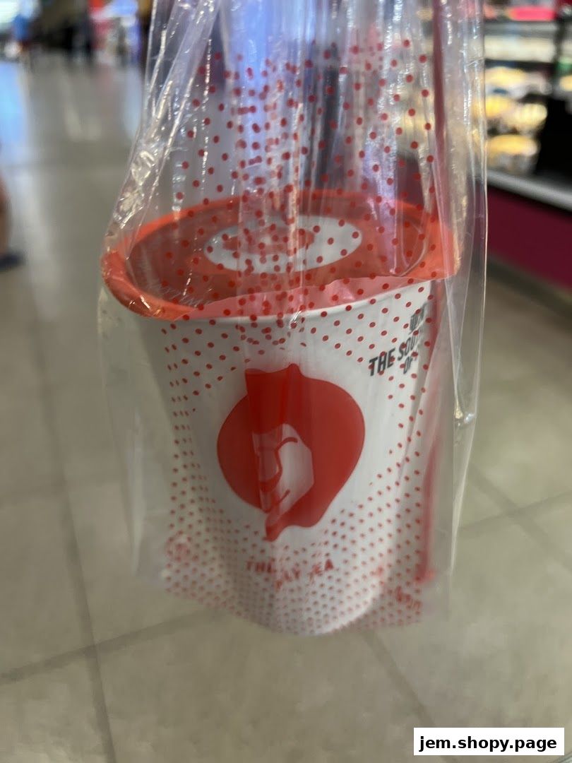 A LiHO TEA cup with red polka dots in a plastic bag.