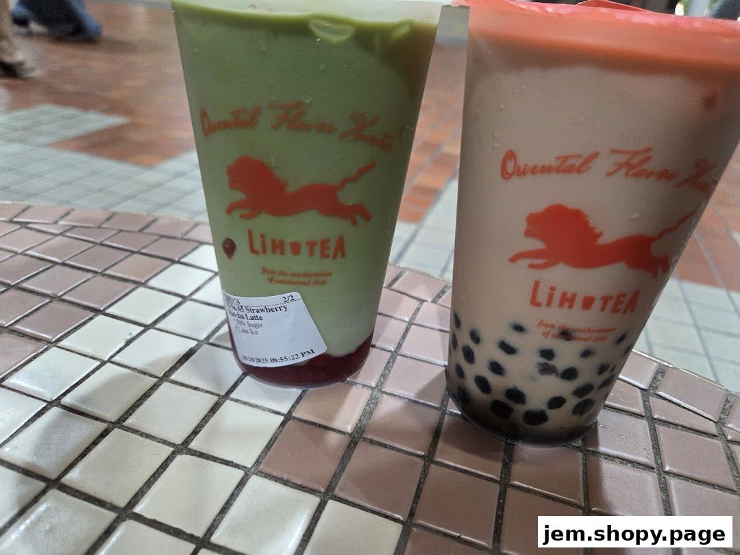 Two cups of LiHO TEA drinks, one matcha latte and one bubble tea, sit on a tiled surface.