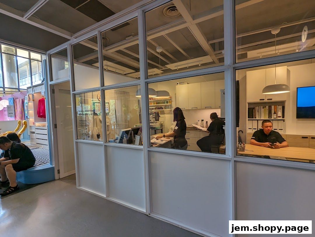 Interior view of a modern retail space with staff working at desks and displays of home goods.