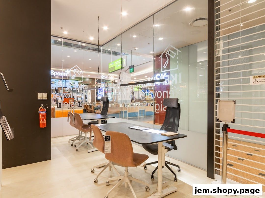 Interior view of a modern office space with desks, chairs, and glass partitions.