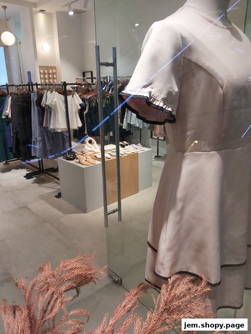 A boutique clothing store display featuring dresses, racks of apparel, and shoes.