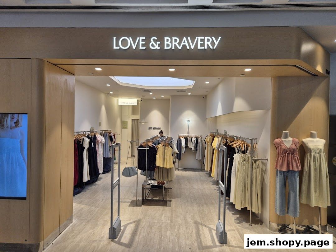 The entrance of Love and Bravery JEM clothing store with racks of apparel and mannequins.